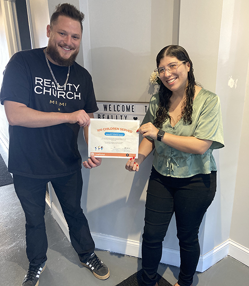 Two people posing with a certificate