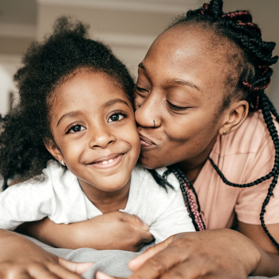 Woman kissiing child on the cheek