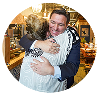 Governor DeSantis huggin a person